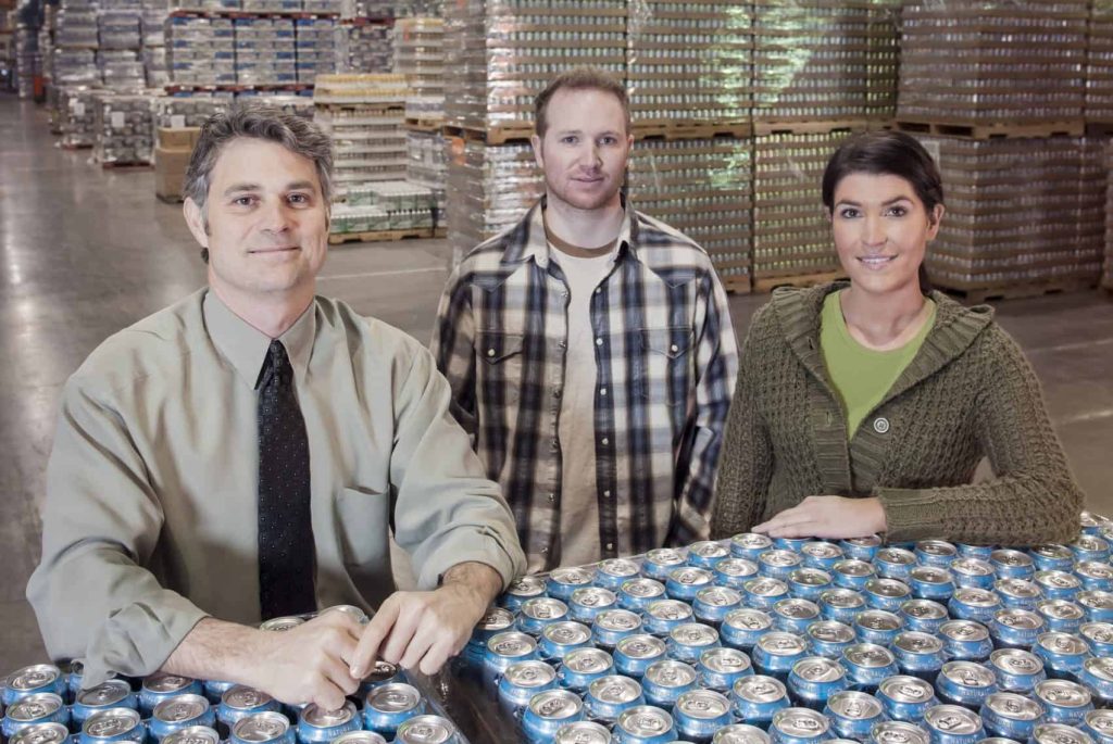 Choosing a beverage can supplier - People standing over cans